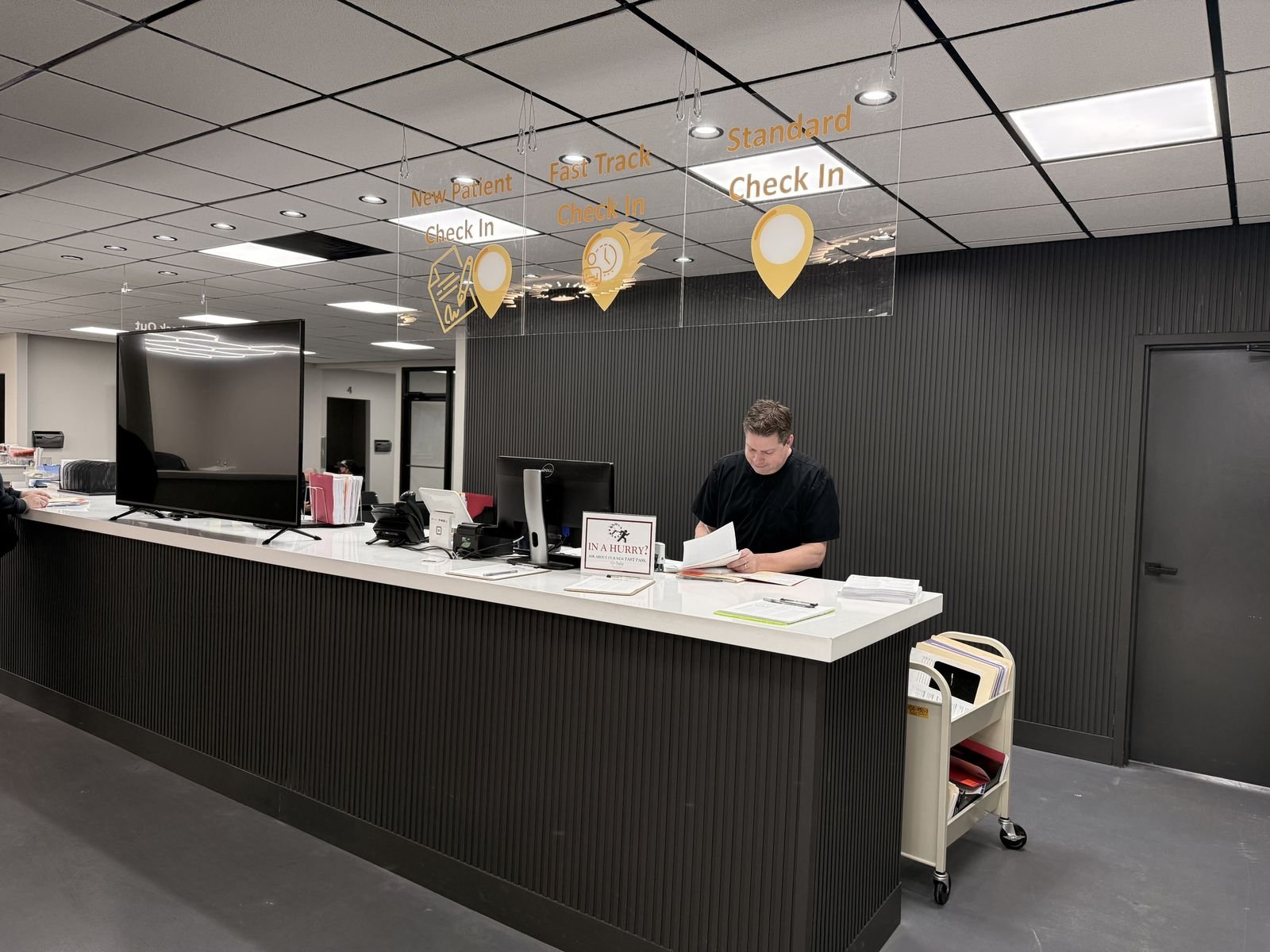 Check-in desk with New Patient, Fast Track, and Standard check-in lanes