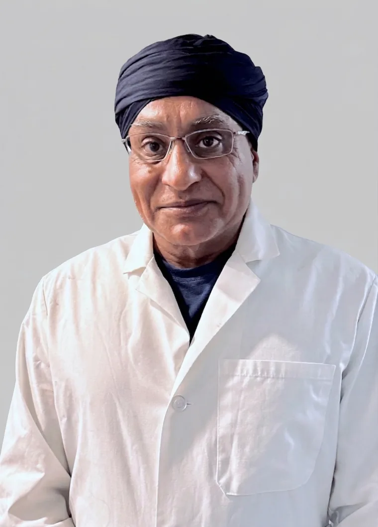 Dr. Gurpreet Singh Padda, MD, MBA, USCIS-designated civil surgeon at ImmigrationExam.us in St. Louis, in a white clinical lab coat