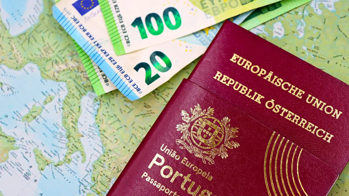 Portugal and Austria passports displayed with Euro currency notes on European map background.